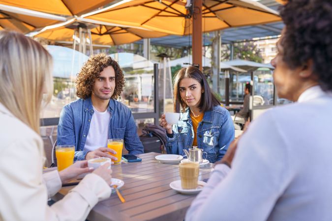 Friends having coffee and juice outside