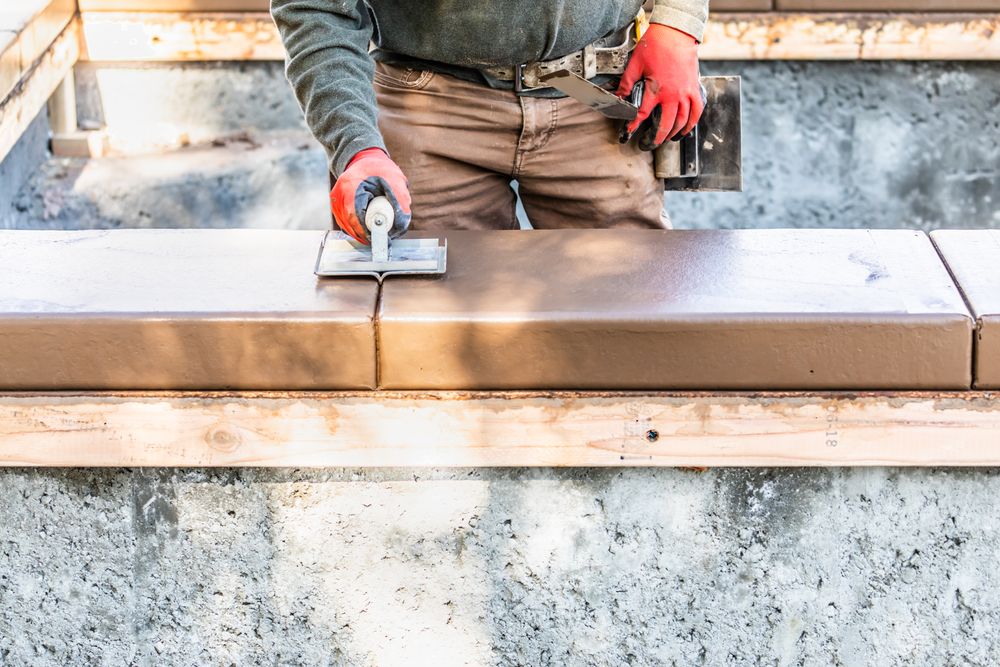 Construction Worker Using Hand Groover On Wet Cement Forming Coping Around New Pool