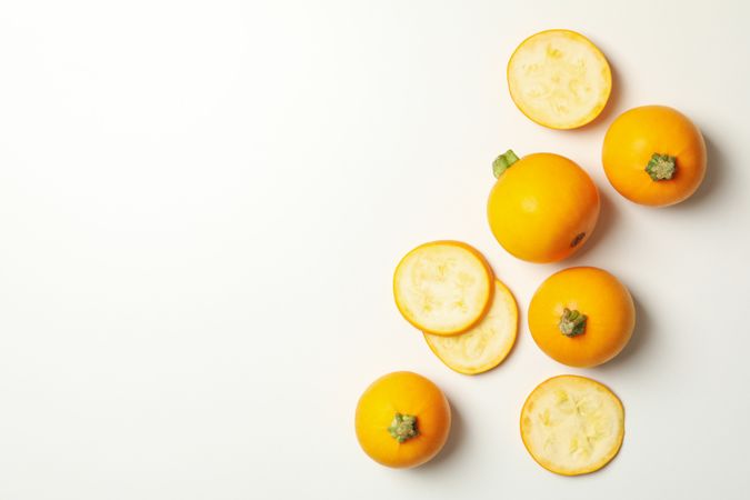 Round zucchini and slices on neutral background, top view