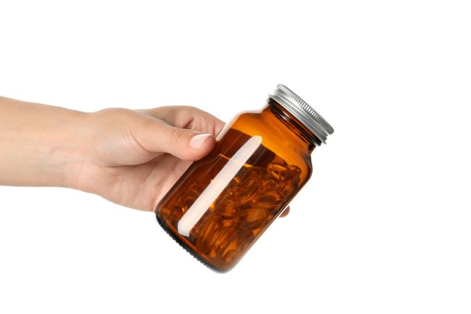 Brown bottle with omega pills, isolated on blank background