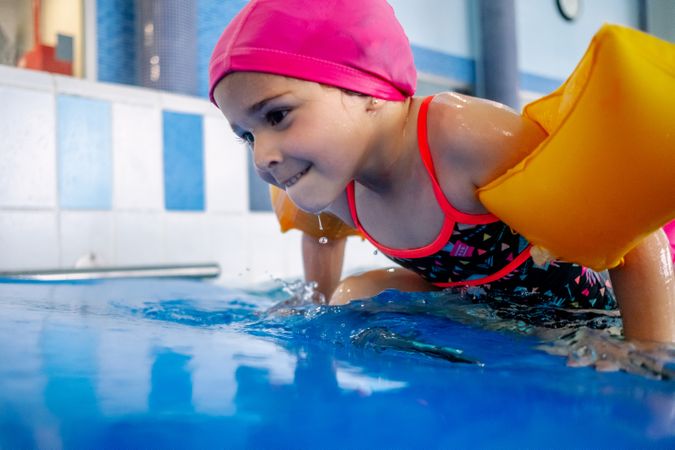 girl with water wings in swimming pool