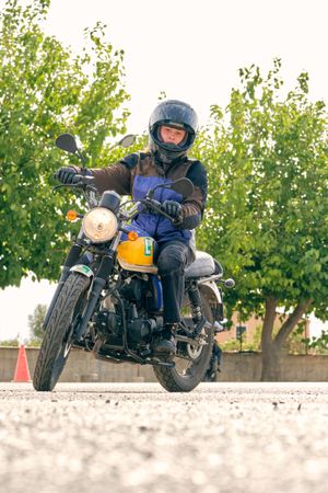 Woman riding motorbike on road on motordrome