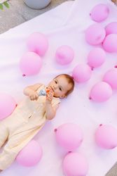 Cute baby on lying with colorful balloons