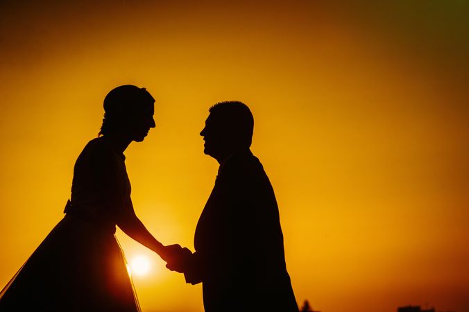 Silhouette of couple in love in setting sun