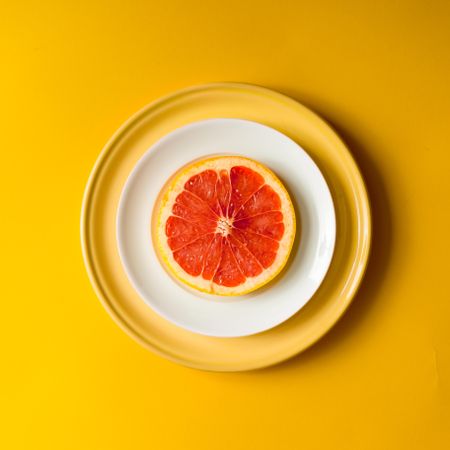 Red grapefruit slice on plate