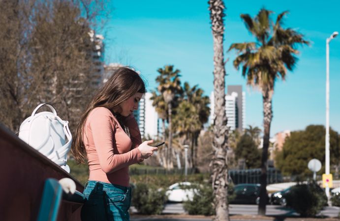 Teen girl looking at her smartphone.