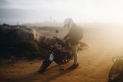 Motorcyclist on cloudy road