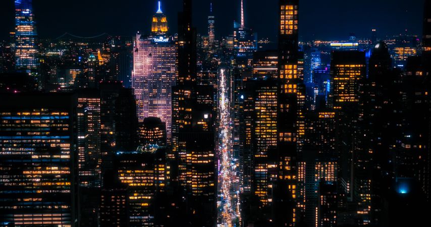 Scenic Aerial New York City View of Downtown Manhattan Architecture. Panoramic Night Photo of the Business District from a Helicopter. Cityscape with Office Buildings and Busy Traffic on Streets