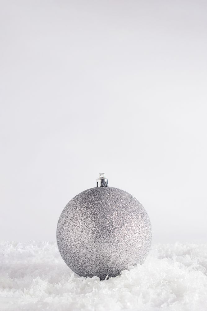 Silver holiday decorations on snow