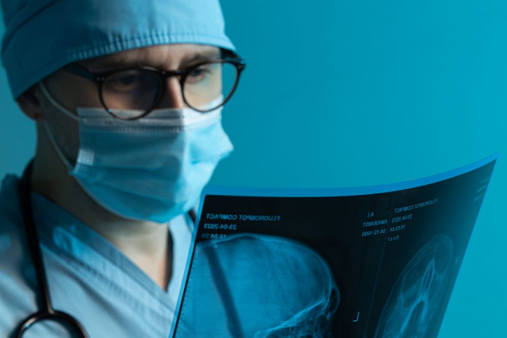 Doctor examining skull X-ray film