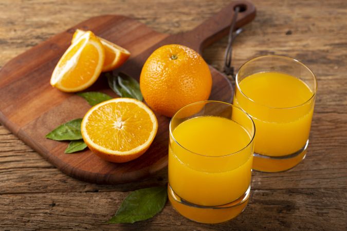 Glass with orange juice on the table.