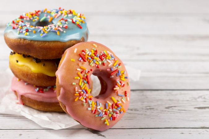 Delicious assorted colorful donuts on the table.