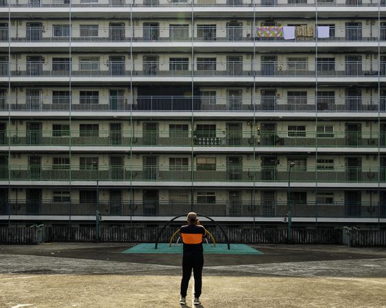 Back view of a man standing in front of a building