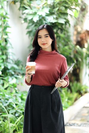 Asian Woman Holding A Cup of Coffee  and Laptop