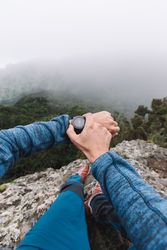 Man's hand with watch in the mountains
