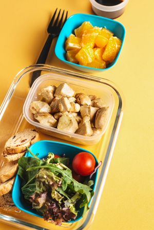 Plastic containers with healthy food and fork