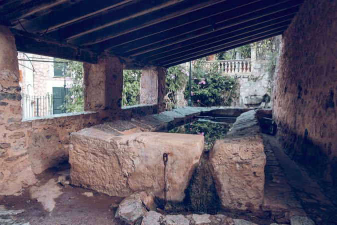 Old abandoned garden with stone reservoir in countryside