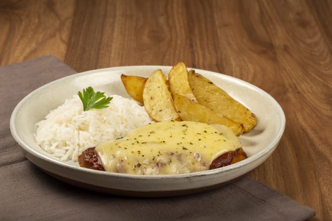 Parmigiana steak with rice and roasted potatoes. Typical Brazilian dish.