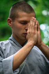 Young man meditating in garden
