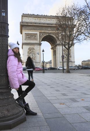 Girl standing against triumphal arch