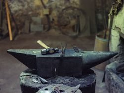 Anvil with hammer and tongs in forge