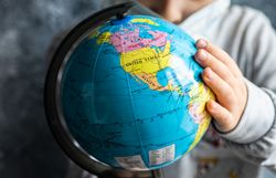 Person holding globe