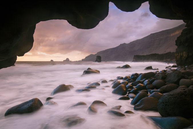 Amazing stone shore and pink sky with clouds