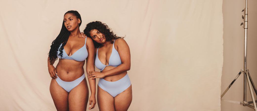 Two confident young women feeling comfortable in their natural bodies and curves