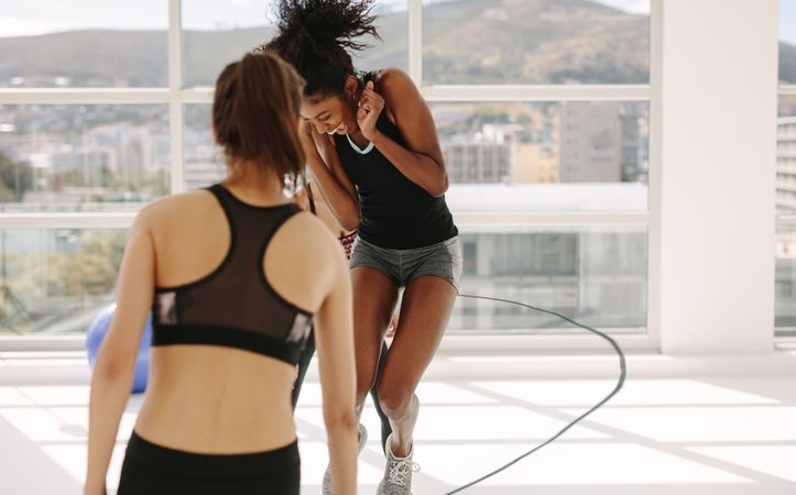 Women having fun during workout session at gym