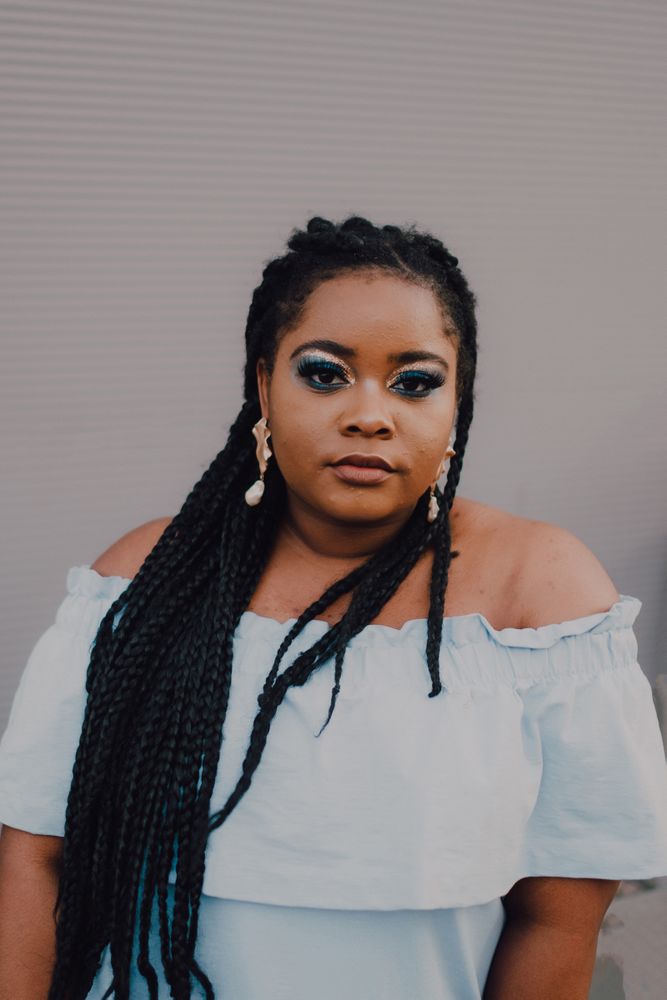 Content trendy Black woman on wall
