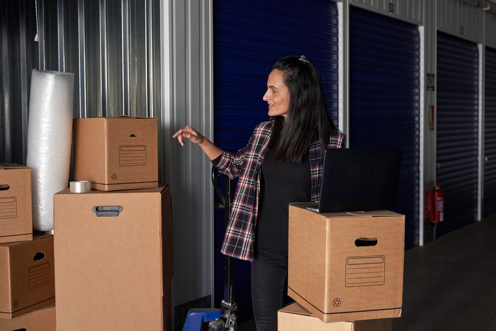 Positive woman observing boxes in container