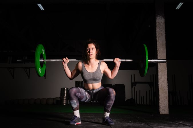 Woman lifting barbell in gym