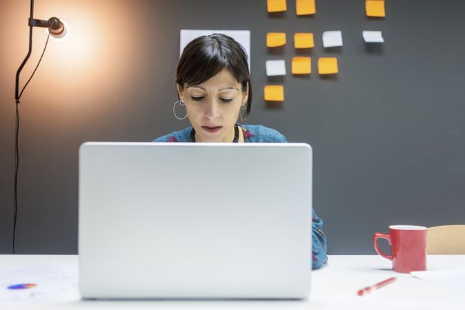 Smiling businesswoman working with laptop