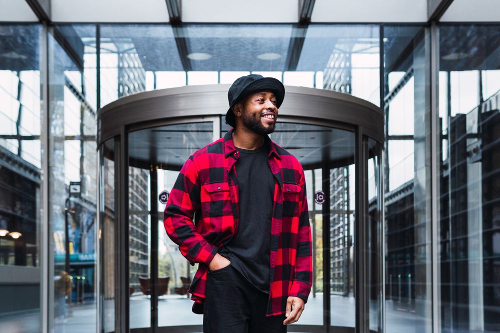 Happy man near glass building entrance