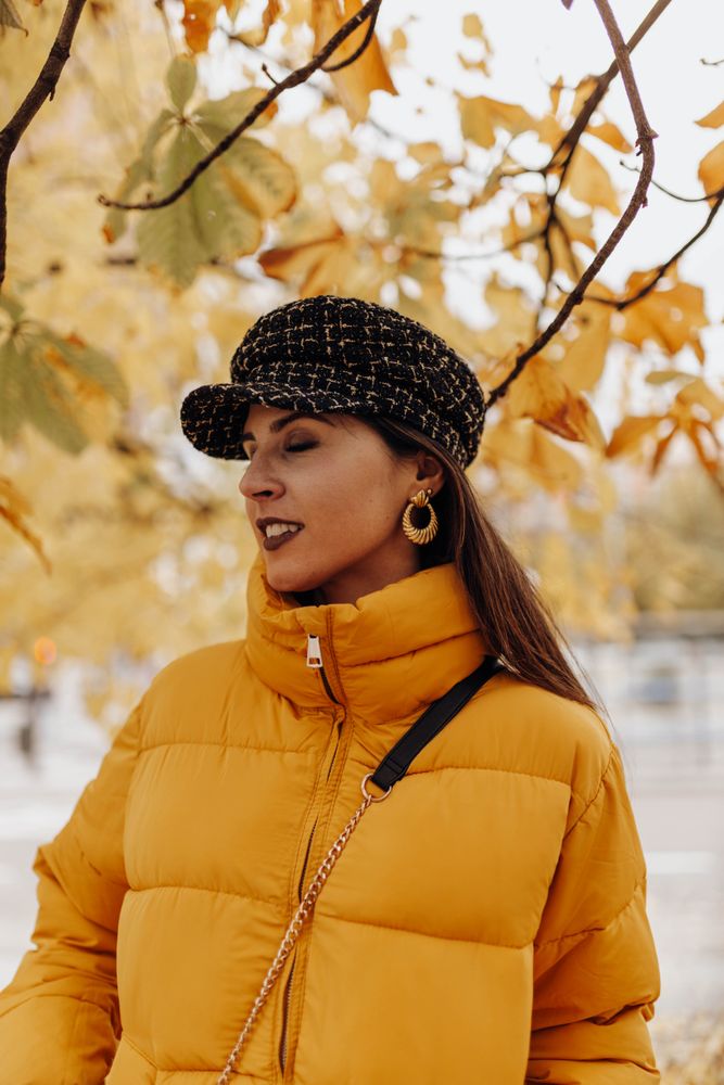 Smiling woman standing on autumn tree