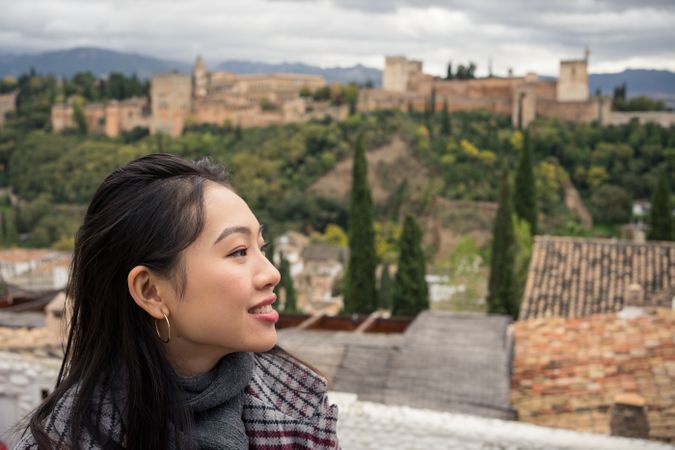 Content female enjoying view of big ancient castle