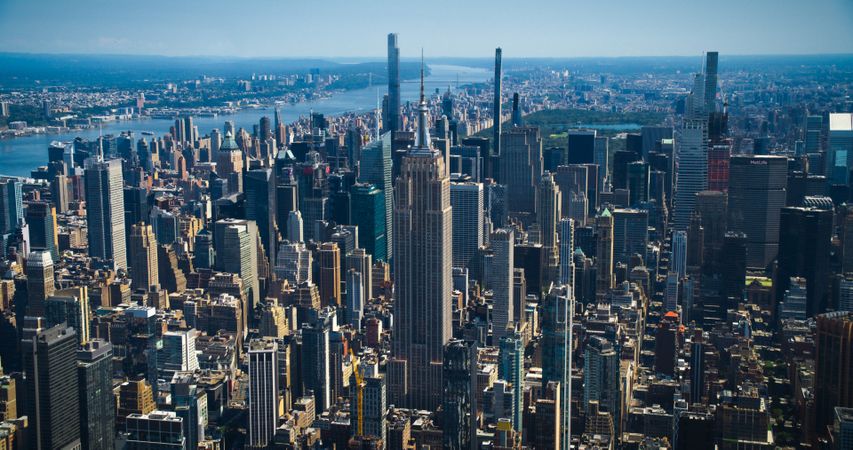 New York City Skyline During Day Time. Aerial Footage from a Helicopter. Empire State Building with Other Famous Urban Landmarks and Skyscraper Buildings. Modern Concrete Jungle Architecture