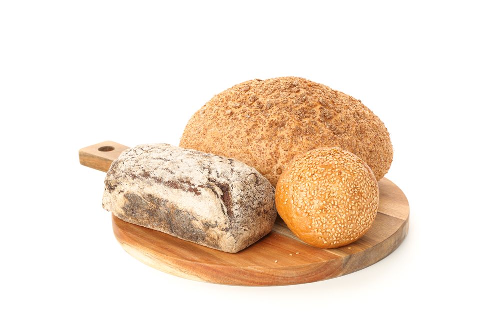 Bakery products on cutting board isolated on blank background