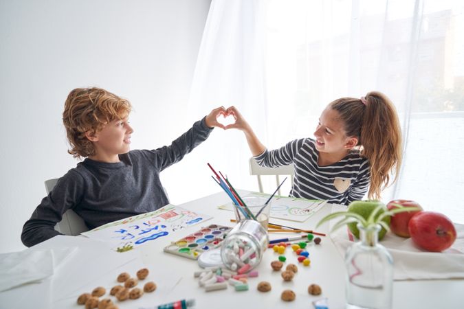 Content children making heart gesture