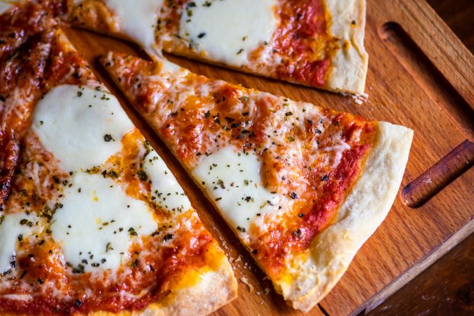 Freshly baked sliced Italian pizza on board
