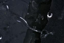 Fragment of thin ice on dark frozen river