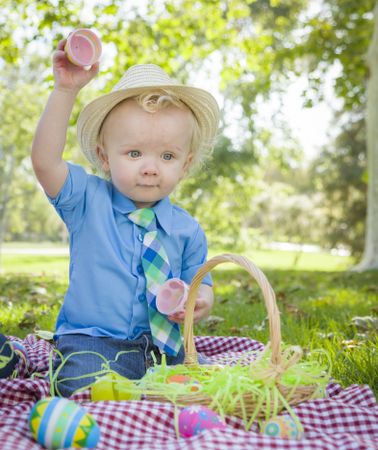 Cute Little Boy Enjoying His Easter Eggs Outside in Park