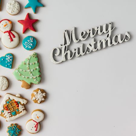 Pattern of Christmas cookies and red berries and “Merry Christmas” text