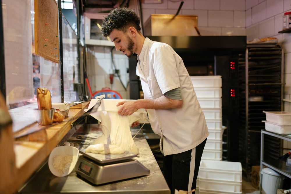 Pizza man taking dough out of a box