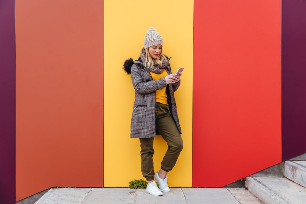 Portrait of blonde woman writing on her phone