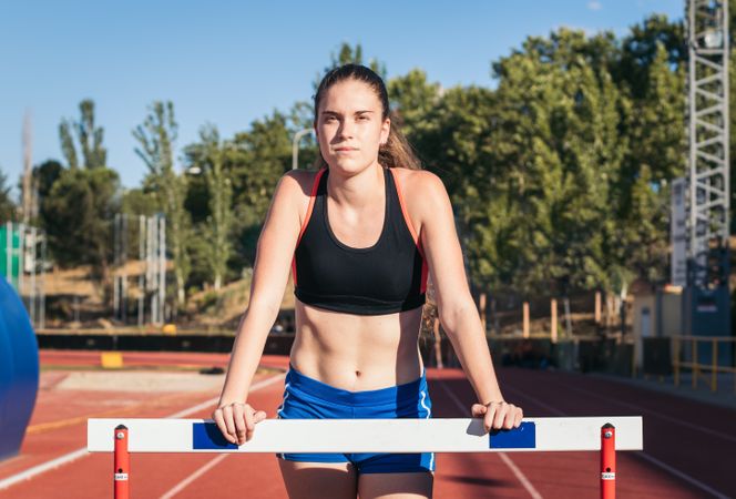 Portrait of a sporty woman on an athletics track.