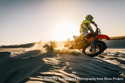 Motocross driver in action driving the motorbike in desert bYQpXb
