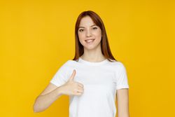 Concept of people, young woman on yellow background