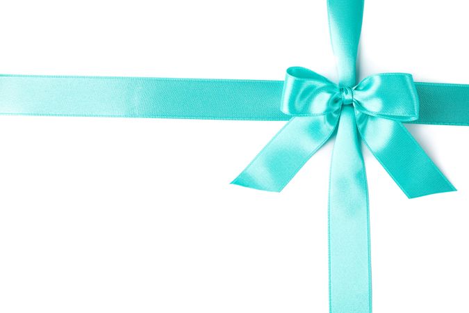 Turquoise ribbon with bow isolated on plain background. Gift concept
