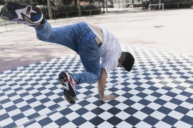 Man dancing break dance in park